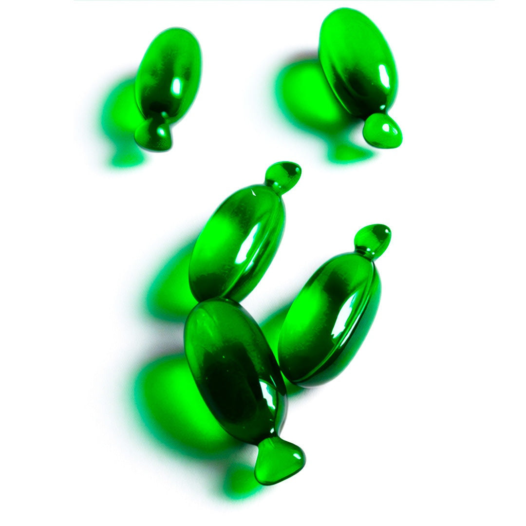 Green capsules of BODYDENSE Vegan Hair Oil for volume and shine on white background