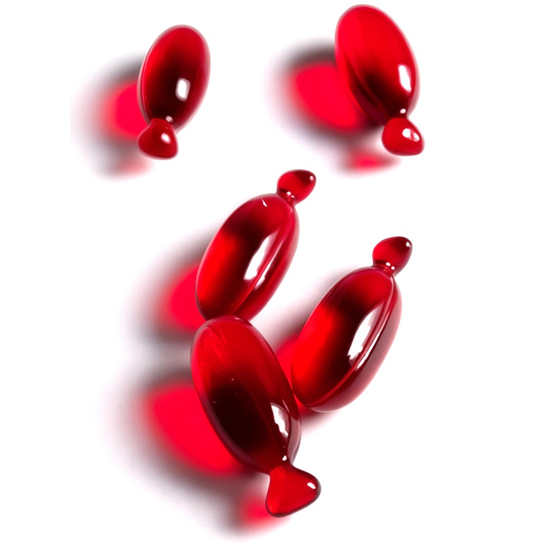 red capsules of vegan hair oil for frizz control and smoothing