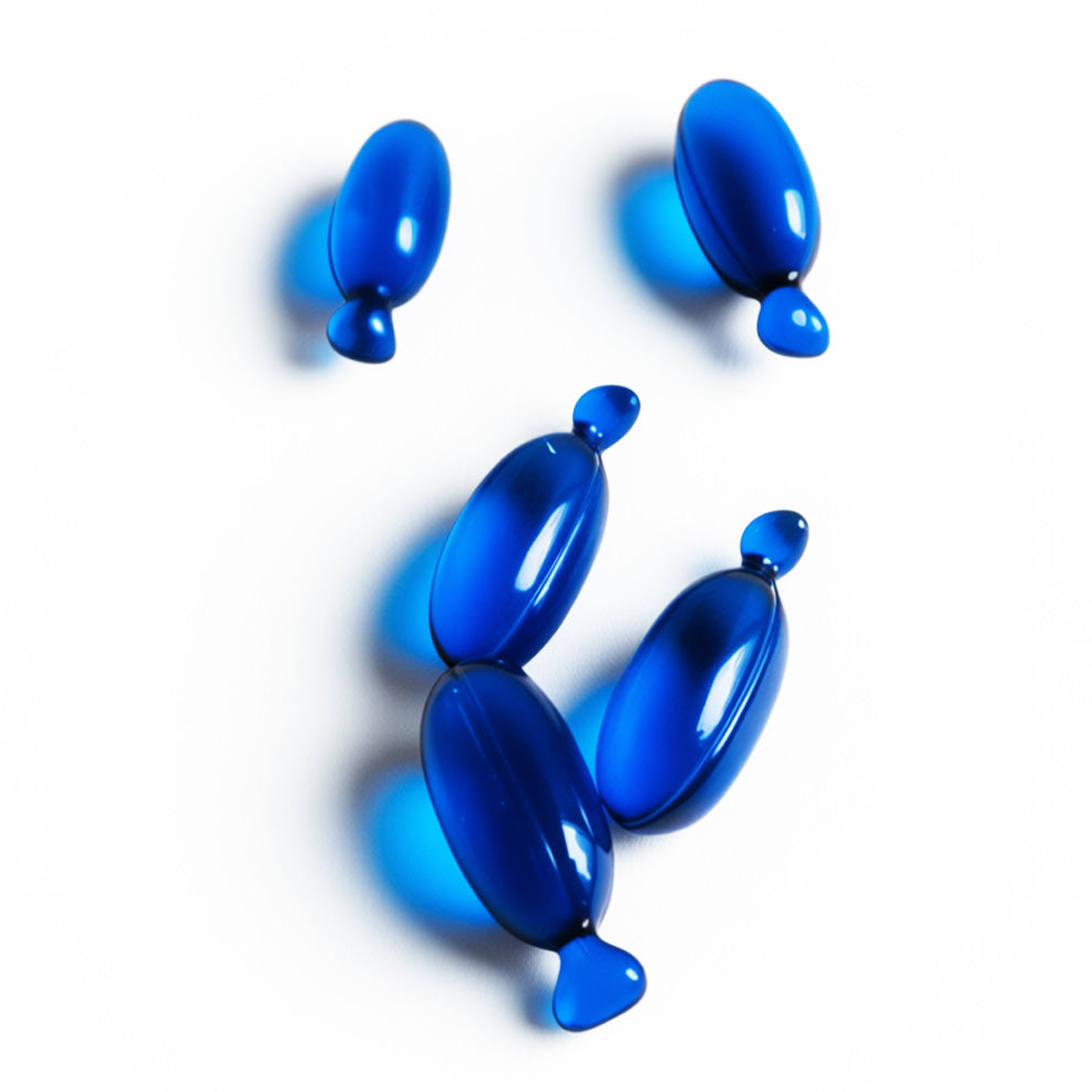 Blue capsules of HYDRAMEND vegan hair oil for hydration and repair