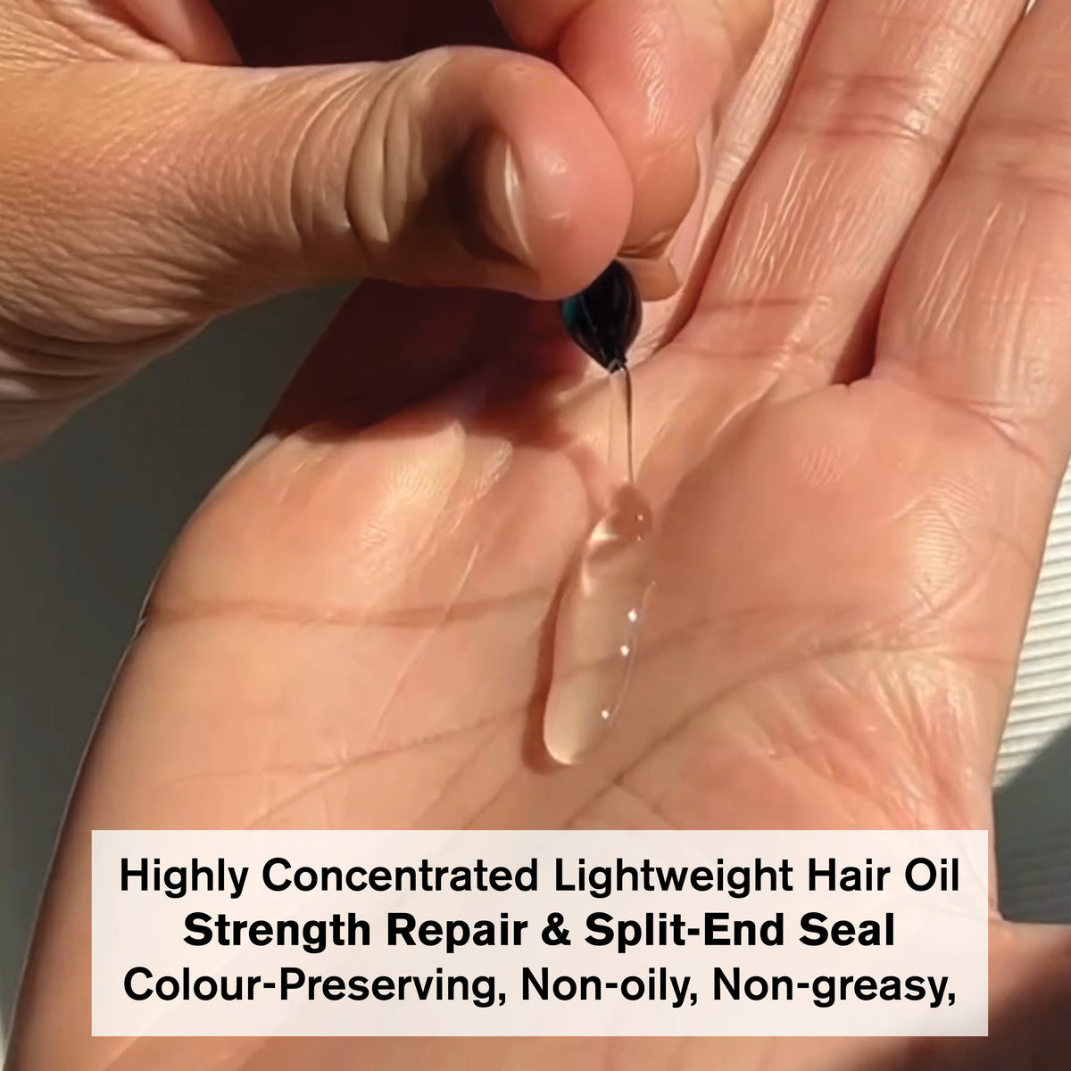 Vegan Hair Oil being dispensed on hand, lightweight formula for strength repair and split-end sealing.