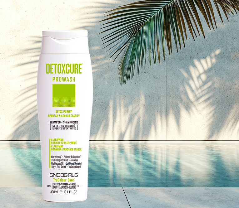 DETOXCURE Prowash Super Concentrated PROWASH Vegan Shampoo bottle by pool with palm shadow background